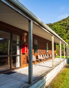 Camp Wainuiomata screen location. Has several buildings and is surrounded by forest and bush.