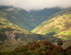 A mountain valley under a cloudy sky.