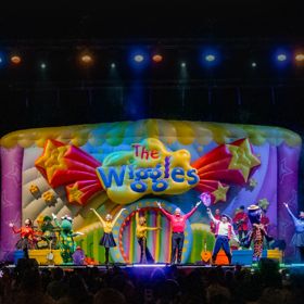 The Wiggles perform on stage.
