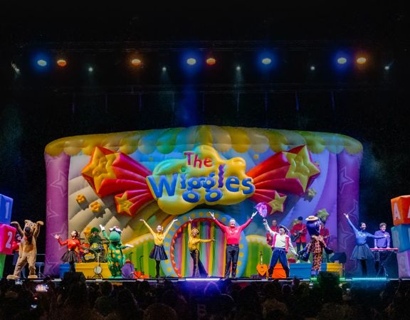 The Wiggles perform on stage.