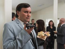 Person talking into a phone on the Small Town Scandal film set