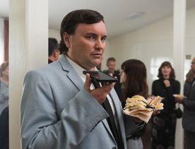 Person talking into a phone on the Small Town Scandal film set