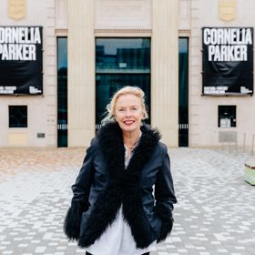 Andrea Schlieker wears a black fur-lined jacket standing outside of City Gallery.