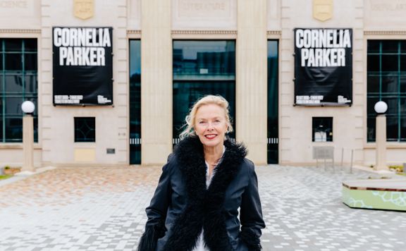Andrea Schlieker wears a black fur-lined jacket standing outside of City Gallery.