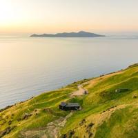 Drone shot above Tunapo Escape, in Paekakākāriki at sunset, with Kapiti Island in the background.