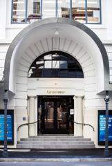 The entrance to Generator on Waring Taylor Street has a concrete curved arch and glass doors.