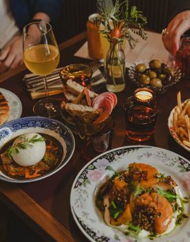 A variety of entrees, sharing plates, and some drinks on a table at The Ram on Cuba Street in Wellington.