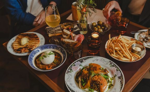 A variety of entrees, sharing plates, and some drinks on a table at The Ram on Cuba Street in Wellington.