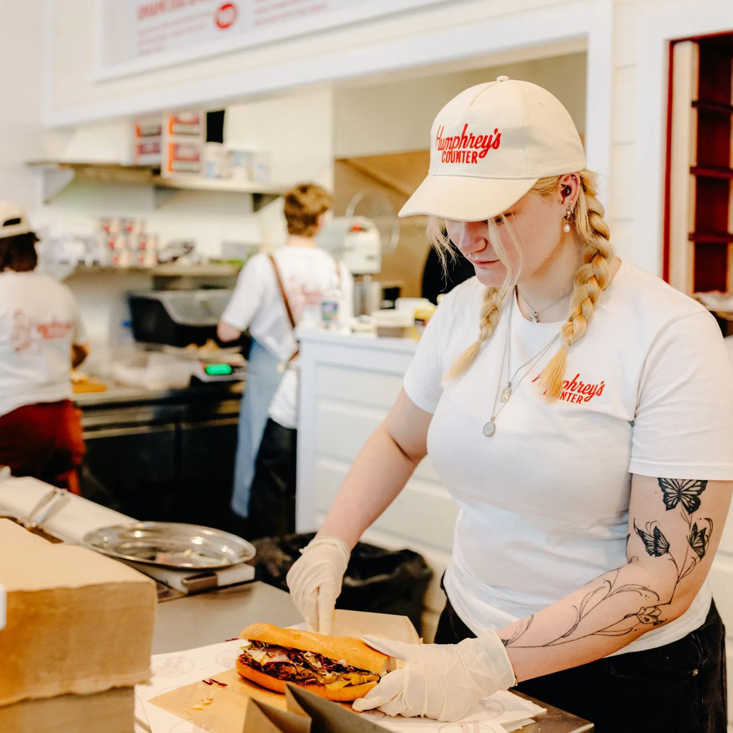 Staff member preparing a sandwich at Humphrey’s Counter in Wellington CBD.