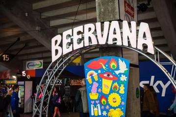 Archway with Beervana lettering atop a steel frame, and a pop-art-styled sign with extraterritorial imagery.