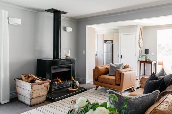 The cozy lounge area of Sudbury Cottage on the Kāpiti Coast.