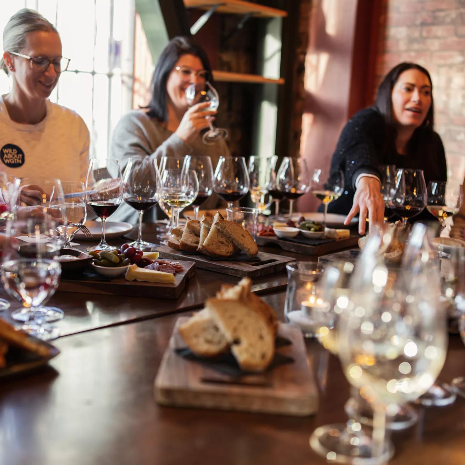 A group of people are doing a wine tasting at Noble Rot, a wine bar located in Te Aro, Wellington.