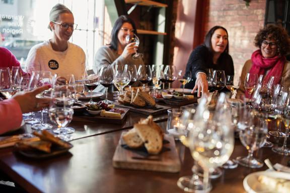 A group of people are doing a wine tasting at Noble Rot, a wine bar located in Te Aro, Wellington.