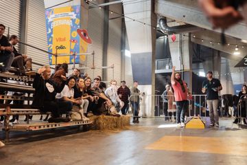 Festival attendees play and watch cornhole at Beervana.
