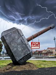 Giant Thor hammer on the Wellington waterfront with a red and white for sale sign hanging off it