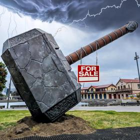 Giant Thor hammer on the Wellington waterfront with a red and white for sale sign hanging off it
