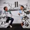 A father and daughter pose with cardboard cut-outs of Mickey and Minnie Mouse on display at the Disney: Magic of Animation exhibition.