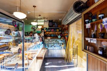 The interior of Olde Beach Bakery Waikanae. It's a small space with the counter along the left and back wall.