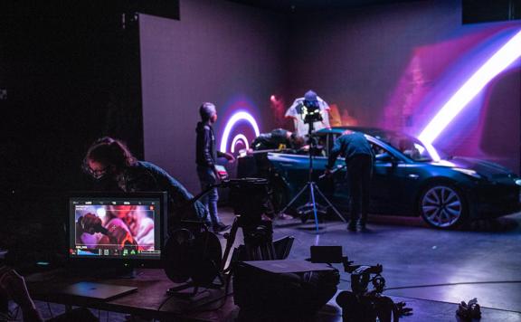 On set of a movie at Avalon Studios in Lower Hutt where they are filming inside a car, with purple lighting surrounding.