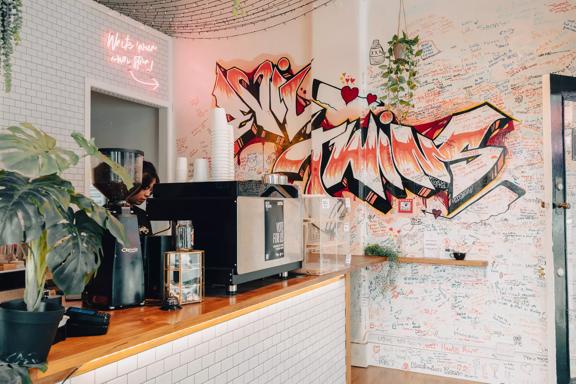 Interior of Evil Twins, focused on the graffiti wall.