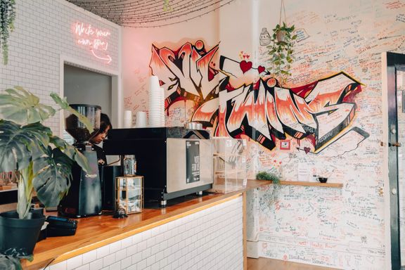 Interior of Evil Twins, focused on the graffiti wall.