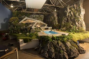 Behind the scenes of ‘Thunderbirds Are Go’. The miniature set of the house is surrounded by rock.