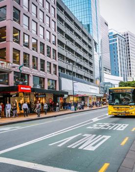A  bus driving down Lambton Quay, a busy street in Wellington's city centre.
