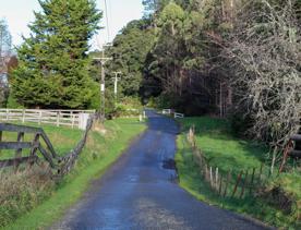 Mangaroa Valley Road screen location, a scenic rural setting with native forest, farmland, and a mountainous backdrop.