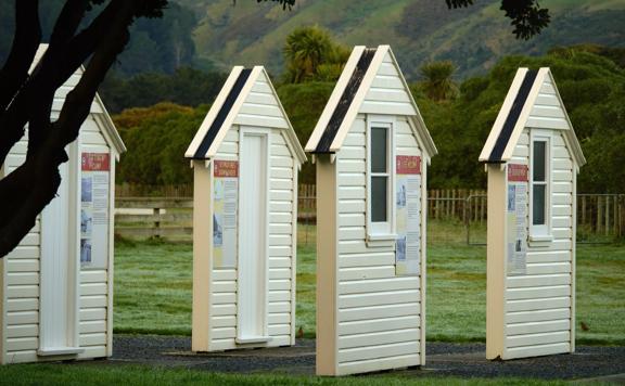 The US Marines Memorial at the start of the Te Ara o Tipapa (Wetland Loop). The memorial is made of four hut facades with informational posters.