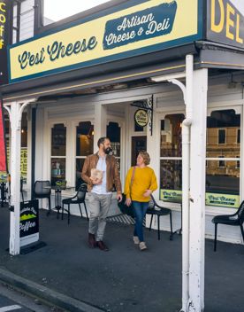Two people are leaving C'est Cheese, an artisan cheese & deli in Featherston, Wairarapa.