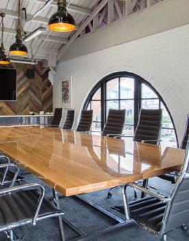 Meeting table inside Harbourside function centre with 14 chairs.