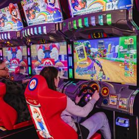 Two people play Super Mario racing arcade game machines in Holey Moley, the mini golf course and bar at Willis Lane located in the Central Business District of Wellington. 