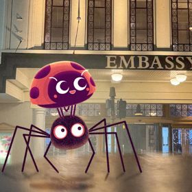 A cartoon spider and ladybug superimposed on a photograph of the Embassy Theatre building in Wellington