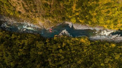 An aerial view of Te Awa Kairangi / Hutt River with three rafts from Wellington Rafting in Upper Hutt.