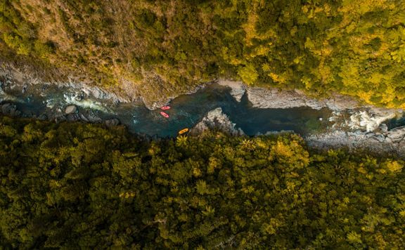 An aerial view of Te Awa Kairangi / Hutt River with three rafts from Wellington Rafting in Upper Hutt.