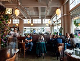 Customers sit inside Floriditas with flowers and dim lighting for the mood.