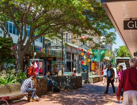 The colourful Bucket Fountain on bustling Cuba Street in Te Aro, Wellington on a sunny day.