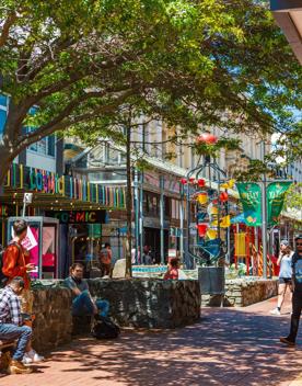 The colourful Bucket Fountain on bustling Cuba Street in Te Aro, Wellington on a sunny day.