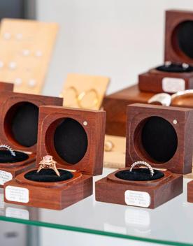 Handmade rings in wooden boxes on a shelf at Rawson Brothers Jewellery in Upper Hutt.