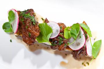 Gremolata crumbed lamb’s brains are topped with radish and green leaves.