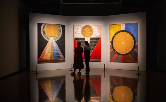 2 people admiring Hilma af Klint The Secret Paintings, City Gallery Wellington, 2021.