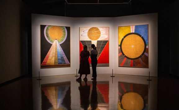 2 people admiring Hilma af Klint The Secret Paintings, City Gallery Wellington, 2021.