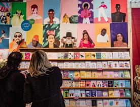 Customers looking at celebrity prints and colourful greetings cards inside Iko Iko.