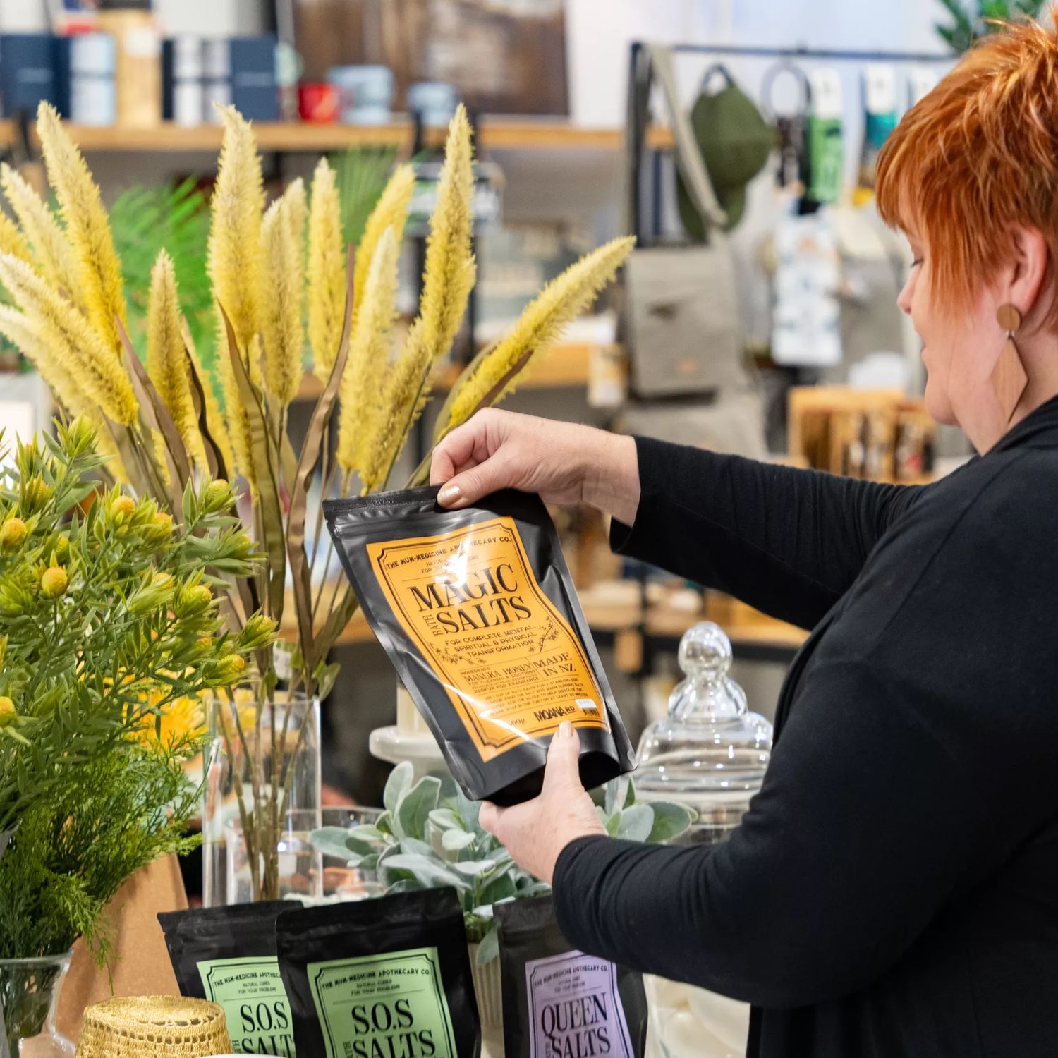 Close-up of a person holding up Magic Bath Salts at  Avison's homeware store in Upper Hutt.