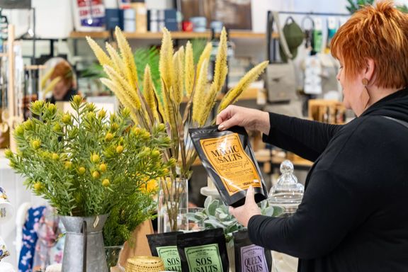 Close-up of a person holding up Magic Bath Salts at  Avison's homeware store in Upper Hutt.