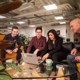 Four people from DataTorque working on a laptop.