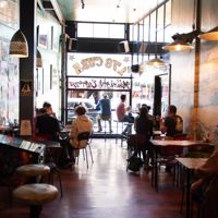 Patrons enjoying food and coffee inside Midnight Espresso, a popular café on Cuba Street in Wellington.