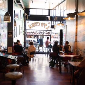 Patrons enjoying food and coffee inside Midnight Espresso, a popular café on Cuba Street in Wellington.