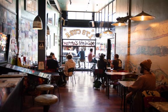 Patrons enjoying food and coffee inside Midnight Espresso, a popular café on Cuba Street in Wellington.