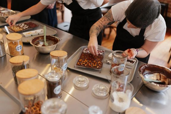 A person decorates chocolate bars at Wellington Chocolate Factory.